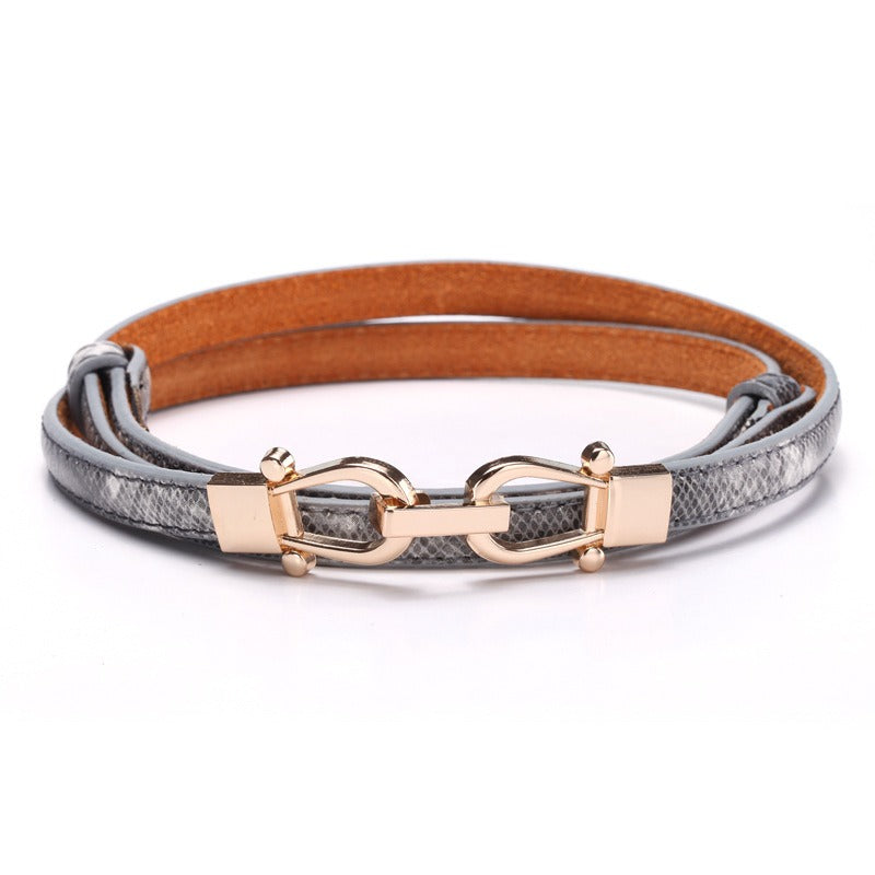 Ceinture en cuir fin pour femme avec bouton couronne et motif serpent