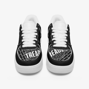 Black low-top sneakers with white laces, white soles, and TREADZ logo graphics on the toe box